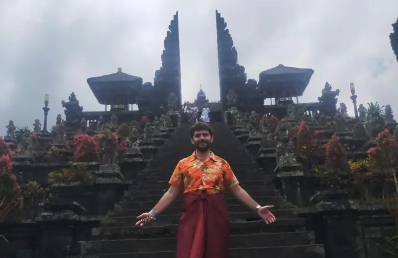 Guest in temple dress at the split gate of Besakih Temple
